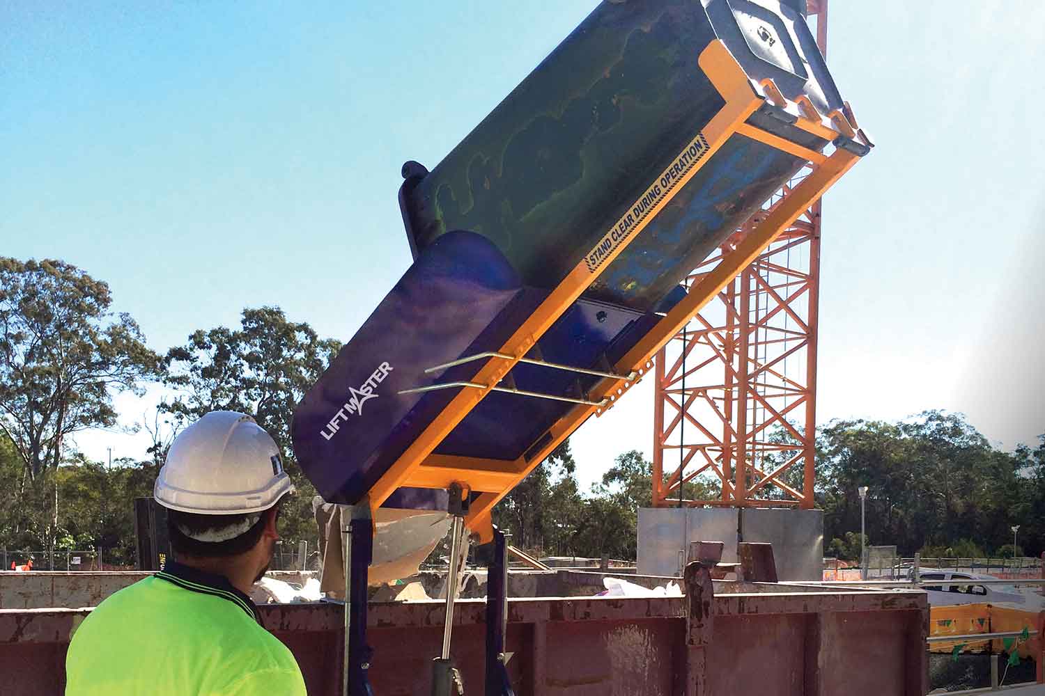 The Liftmaster Rugged powered bin lifter/tipper on a construction site 