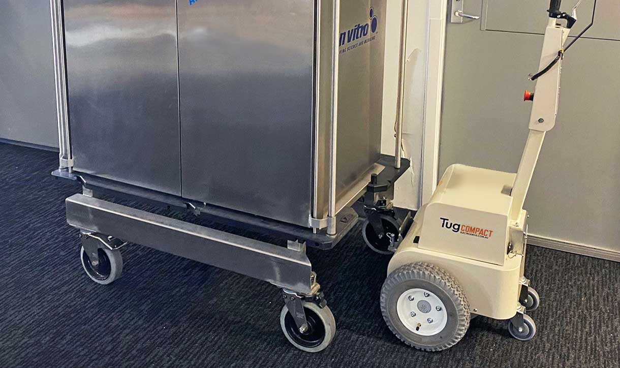 Tug Compact towing a sterile medical equipment trolley